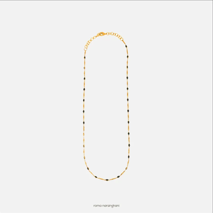 Roma Narsinghani Black Gold sunglass chain Sunglass chain / Choker The piece is set in brass, Black beads with 18KT gold finesse. Each piece is unique and handcrafted by our artisans. RNLOVE13